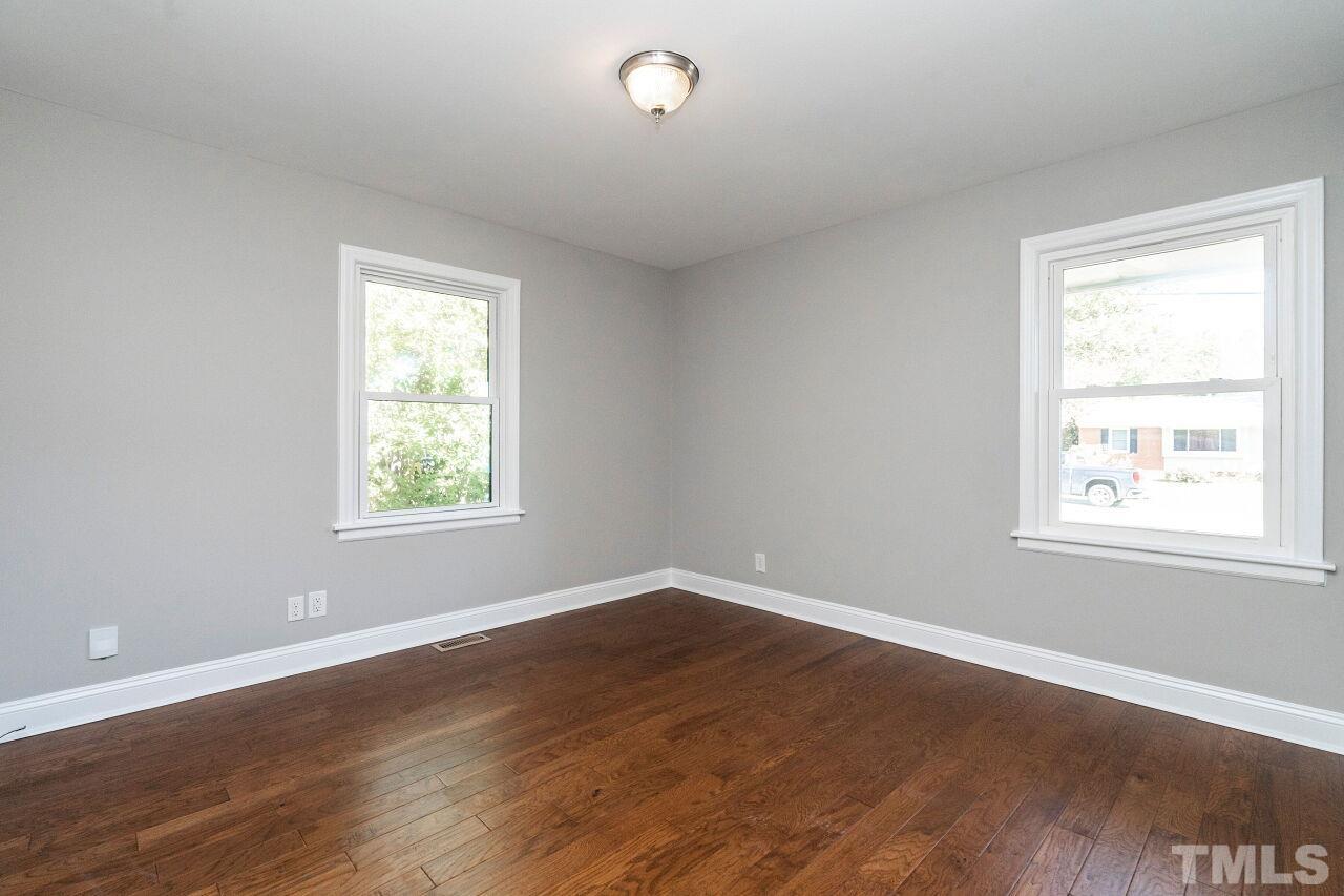 1105 Brighton Road Raleigh, NC 27610 - Photo 17 of 22 an empty room with wooden floor and windows