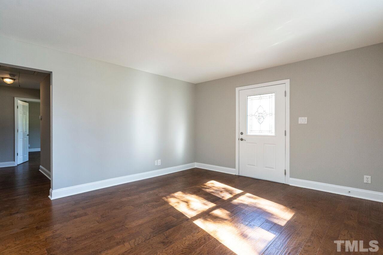 1105 Brighton Road Raleigh, NC 27610 - Photo 5 of 22 a view of empty room with wooden floor and fan