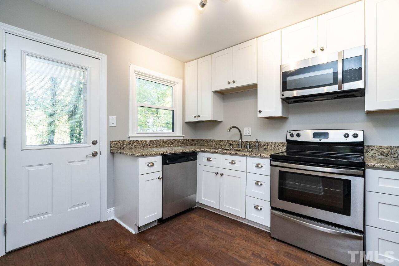 1105 Brighton Road Raleigh, NC 27610 - Photo 8 of 22 a kitchen with stainless steel appliances granite countertop a stove and a white cabinets