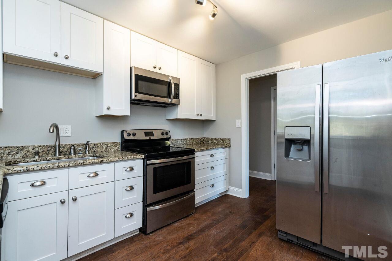 1105 Brighton Road Raleigh, NC 27610 - Photo 10 of 22 a kitchen with stainless steel appliances granite countertop a refrigerator stove and sink