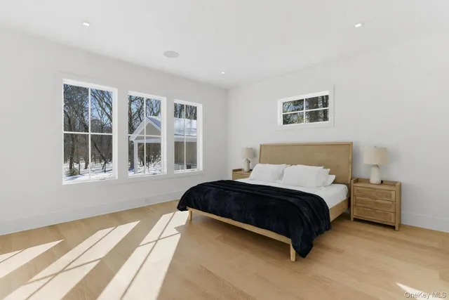 a spacious bedroom with a bed and a window