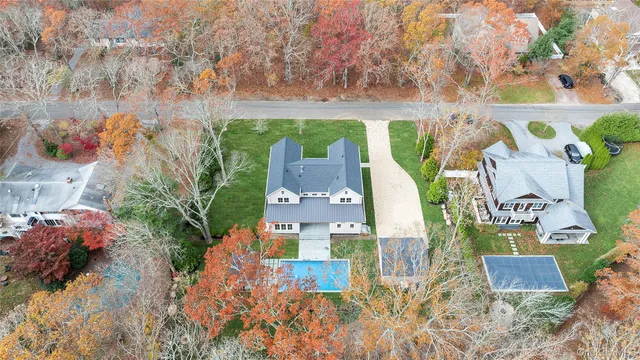 an aerial view of a house with a yard and lake view