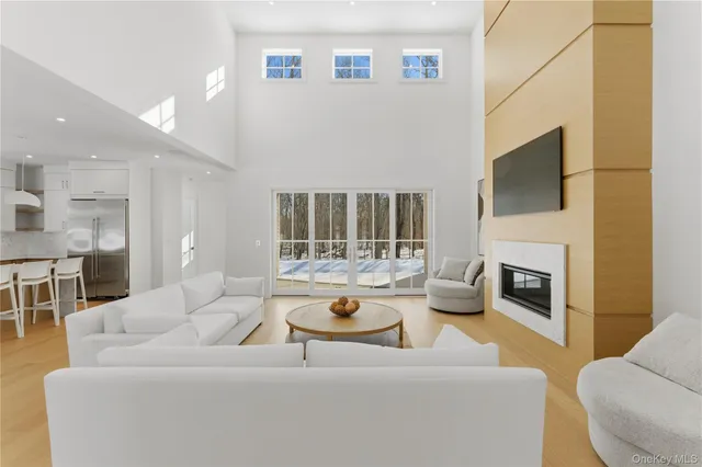a living room with furniture a fireplace and a flat screen tv