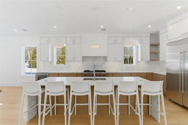 a kitchen with stainless steel appliances a dining table and chairs