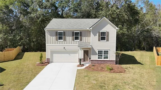 a front view of a house with a yard