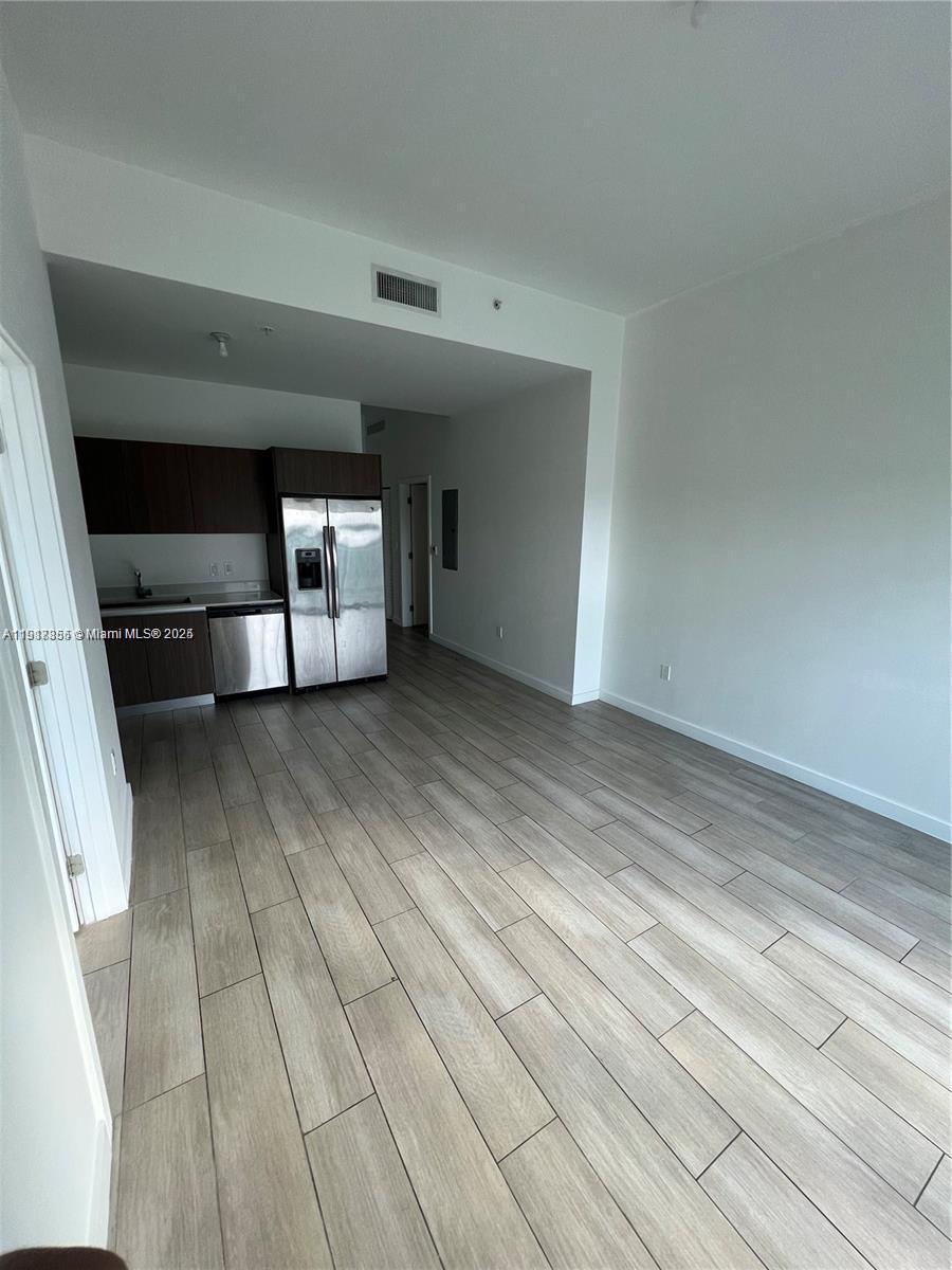1600 Southwest 1st Avenue, Unit 412 Miami, FL 33129 - Photo 2 of 12 a view of a hallway with wooden floor and staircase