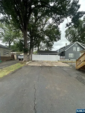 an empty room with windows and hardwood floor