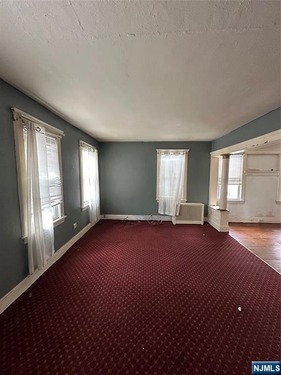 213 Van Winkle Avenue Hawthorne, NJ 07506 - Photo 5 of 7 an empty room with windows and hardwood floor
