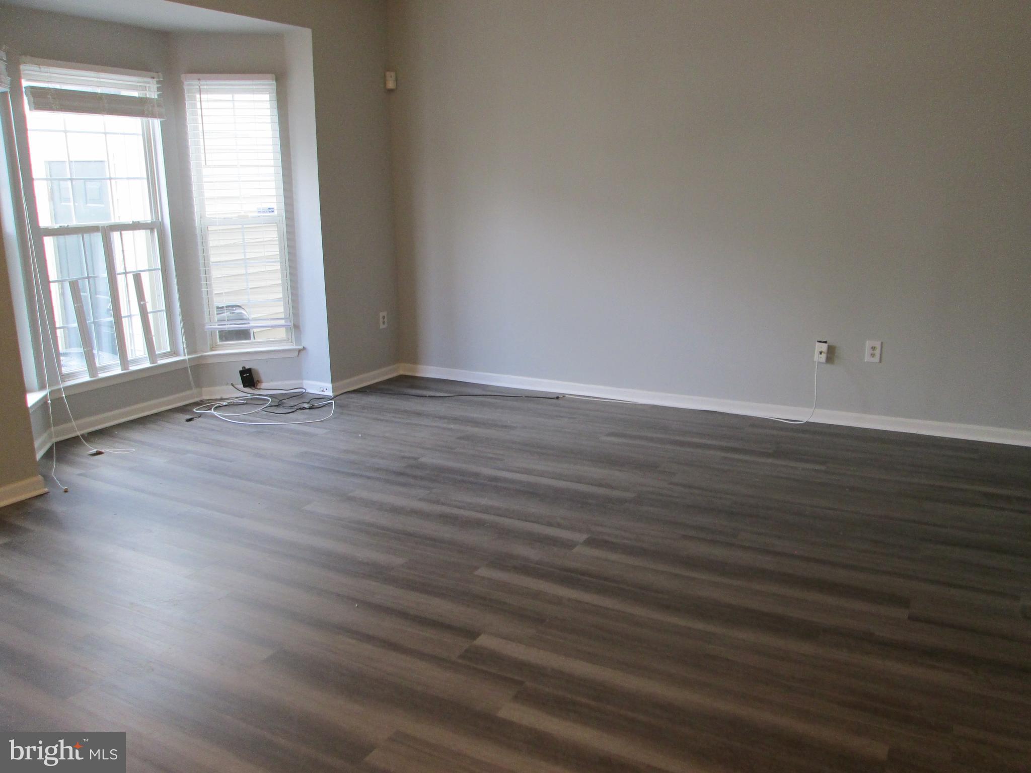2004 Travis Point Court Odenton, MD 21113 - Photo 7 of 14 a view of an empty room with wooden floor and a window