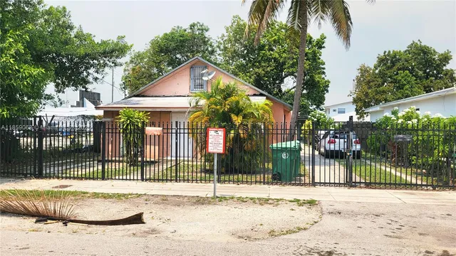a view of a house with a small yard and plants