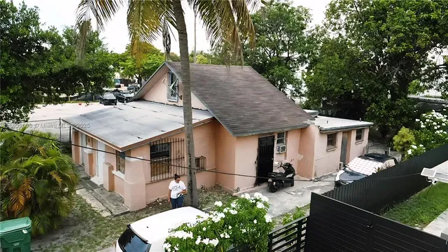 aerial view of a house with a yard balcony and sink