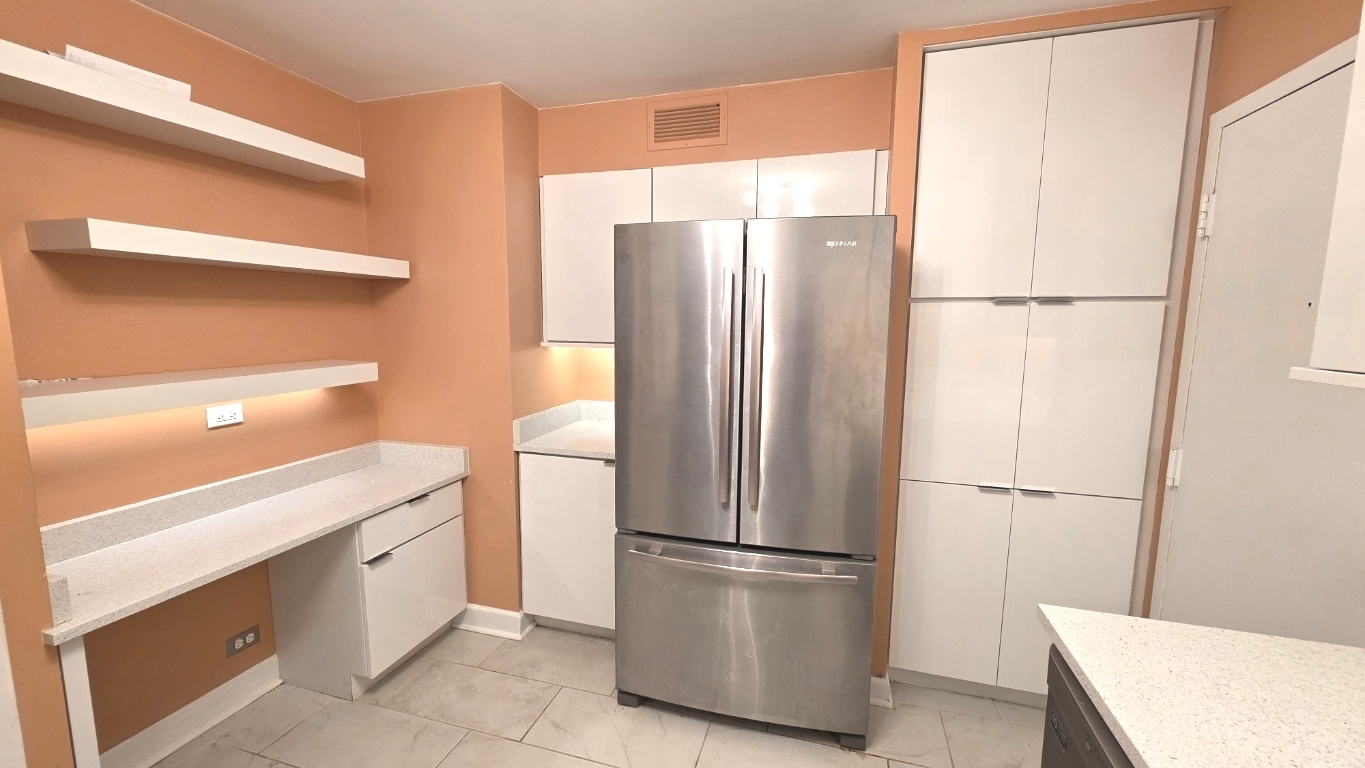 6033 North Sheridan Road, Unit 5G Chicago, IL 60660 - Photo 7 of 24 a white refrigerator freezer and a wooden floor