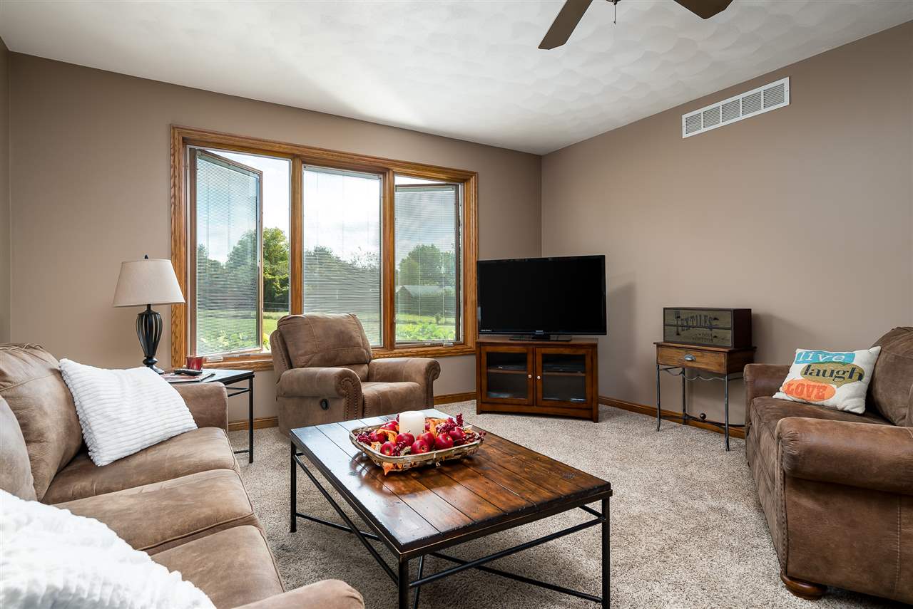 80 North Creek Road Roscoe, IL 61073 - Photo 13 of 25 a living room with furniture and a flat screen tv