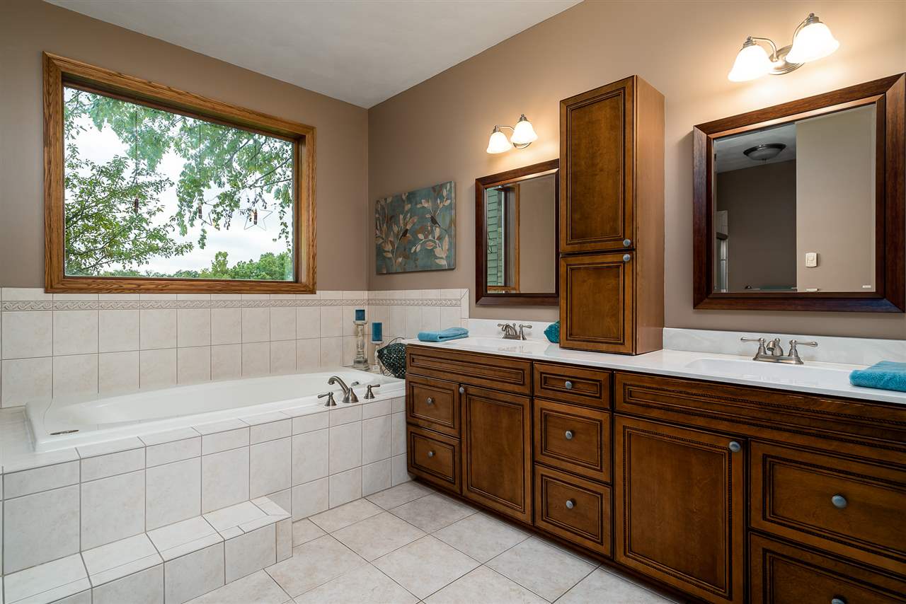 80 North Creek Road Roscoe, IL 61073 - Photo 17 of 25 a bathroom with a tub sink and mirror