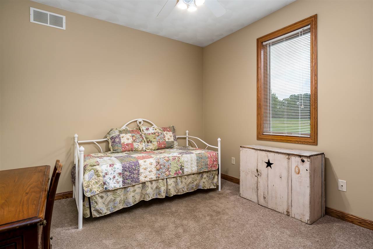 80 North Creek Road Roscoe, IL 61073 - Photo 18 of 25 a bedroom with a bed and a window