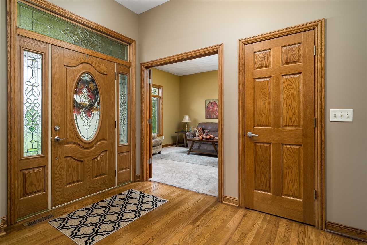 80 North Creek Road Roscoe, IL 61073 - Photo 3 of 25 a hallway with sliding door and wooden floor