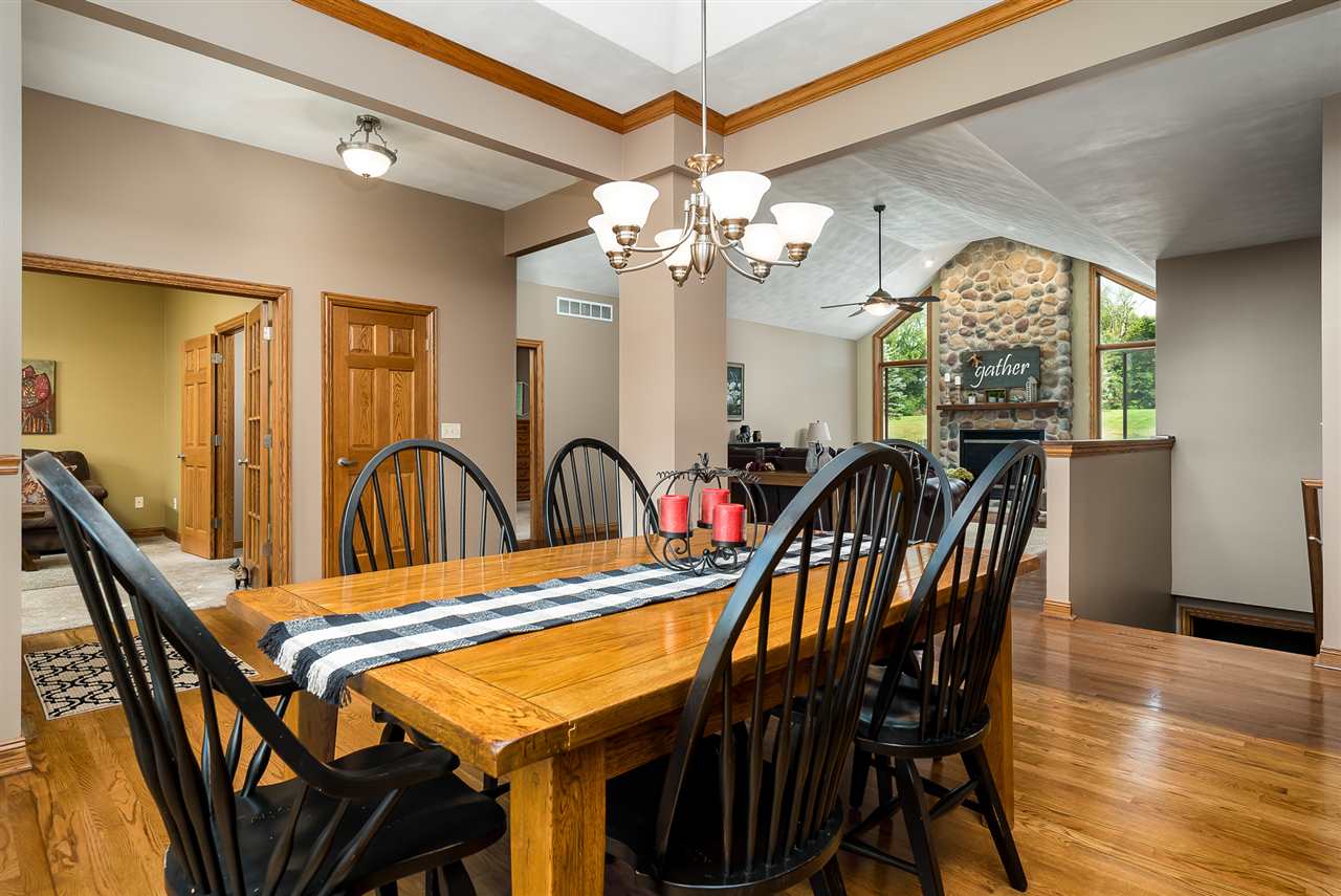 80 North Creek Road Roscoe, IL 61073 - Photo 4 of 25 a view of a dining room with furniture window and wooden floor