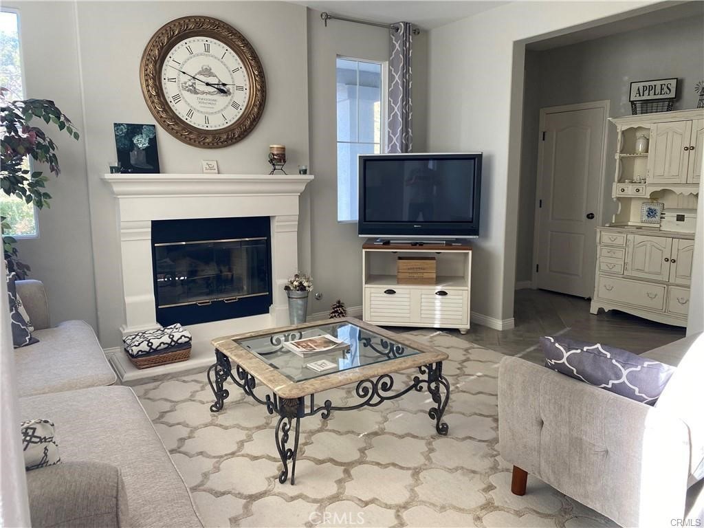 23 Bedstraw Loop Ladera Ranch, CA 92694 - Photo 12 of 37 a living room with furniture a flat screen tv and a fireplace