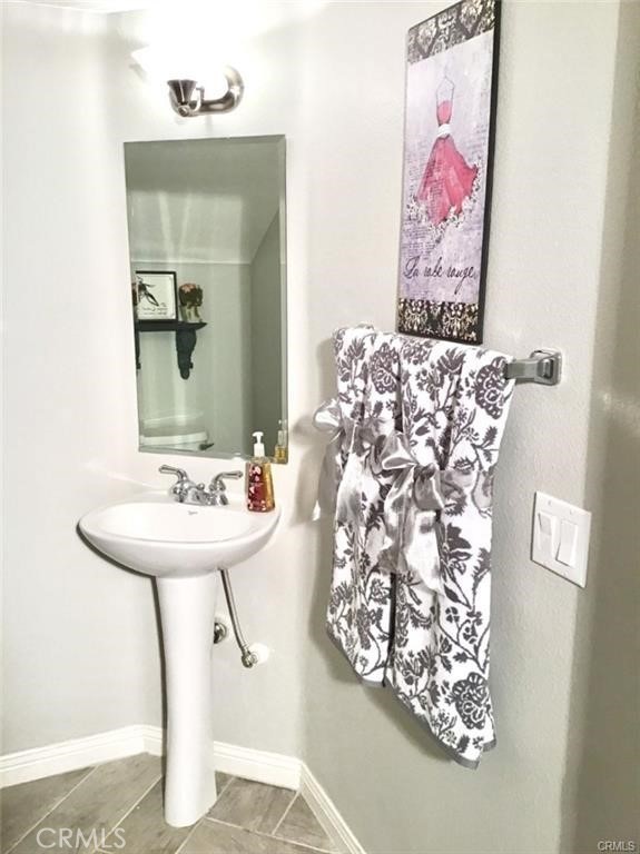 23 Bedstraw Loop Ladera Ranch, CA 92694 - Photo 15 of 37 a bathroom with a sink and mirror with painted walls