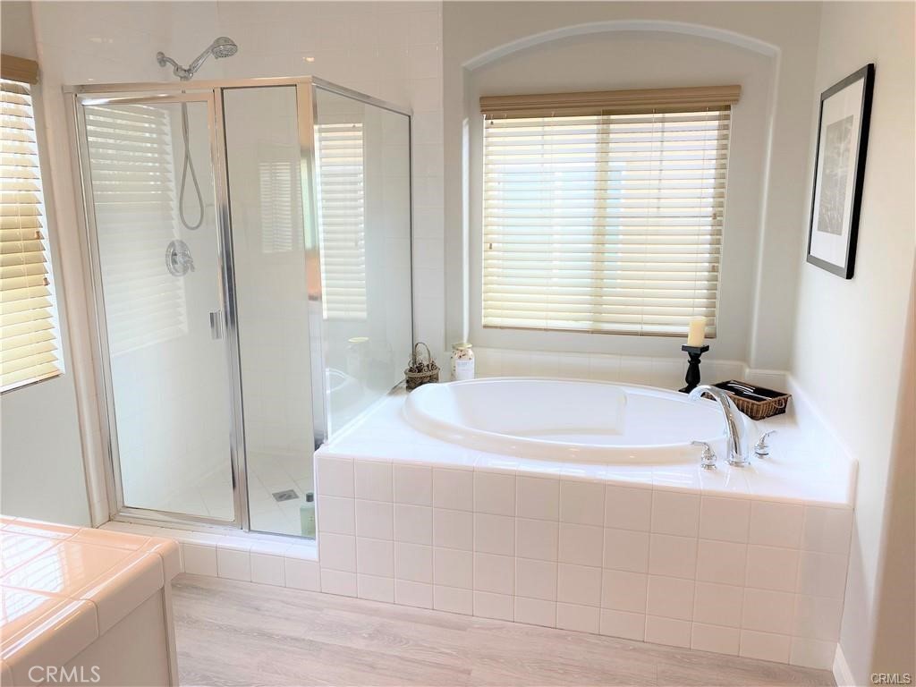 23 Bedstraw Loop Ladera Ranch, CA 92694 - Photo 18 of 37 a white bath tub sitting in a bathroom next to a window