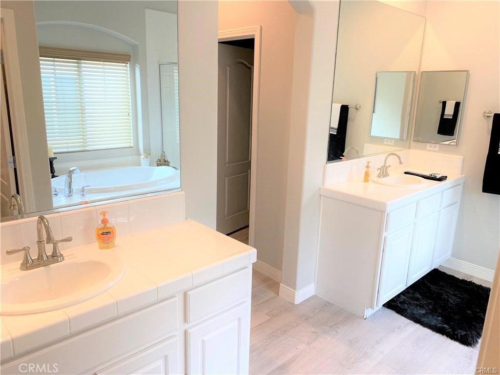 23 Bedstraw Loop Ladera Ranch, CA 92694 - Photo 20 of 37 a bathroom with a sink and a mirror