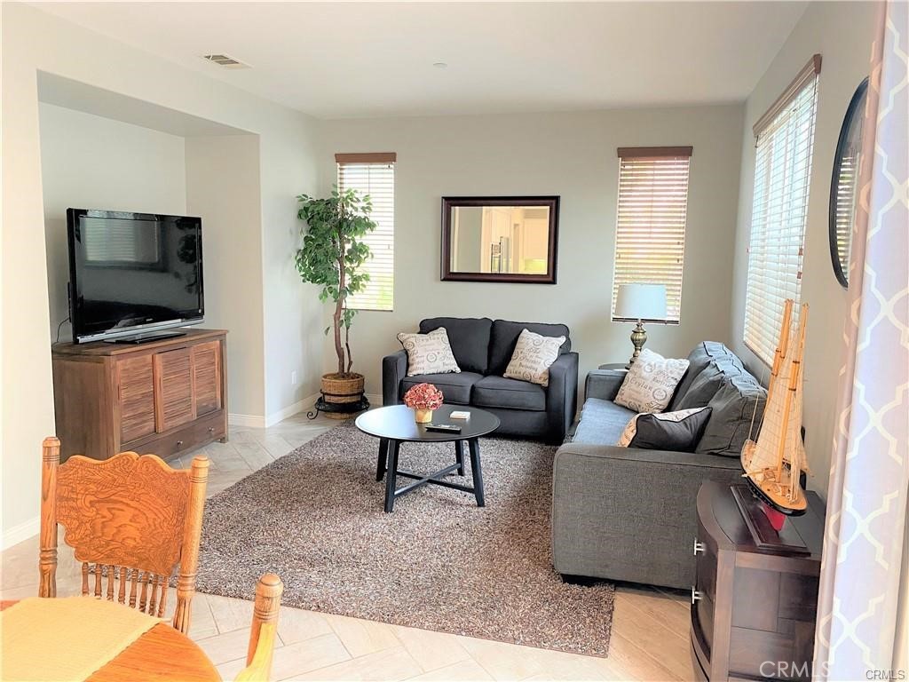 23 Bedstraw Loop Ladera Ranch, CA 92694 - Photo 2 of 37 a living room with furniture and a flat screen tv