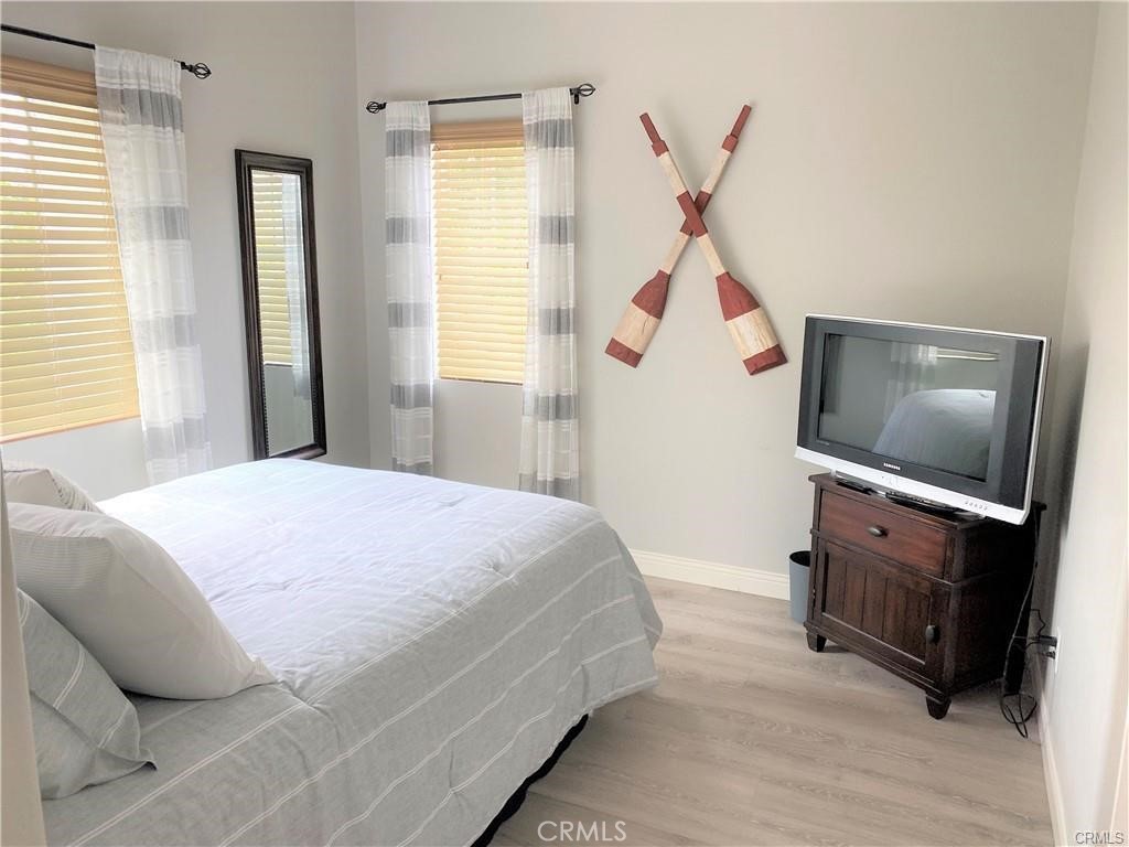 23 Bedstraw Loop Ladera Ranch, CA 92694 - Photo 23 of 37 a bedroom with a bed and a flat tv screen on the dresser