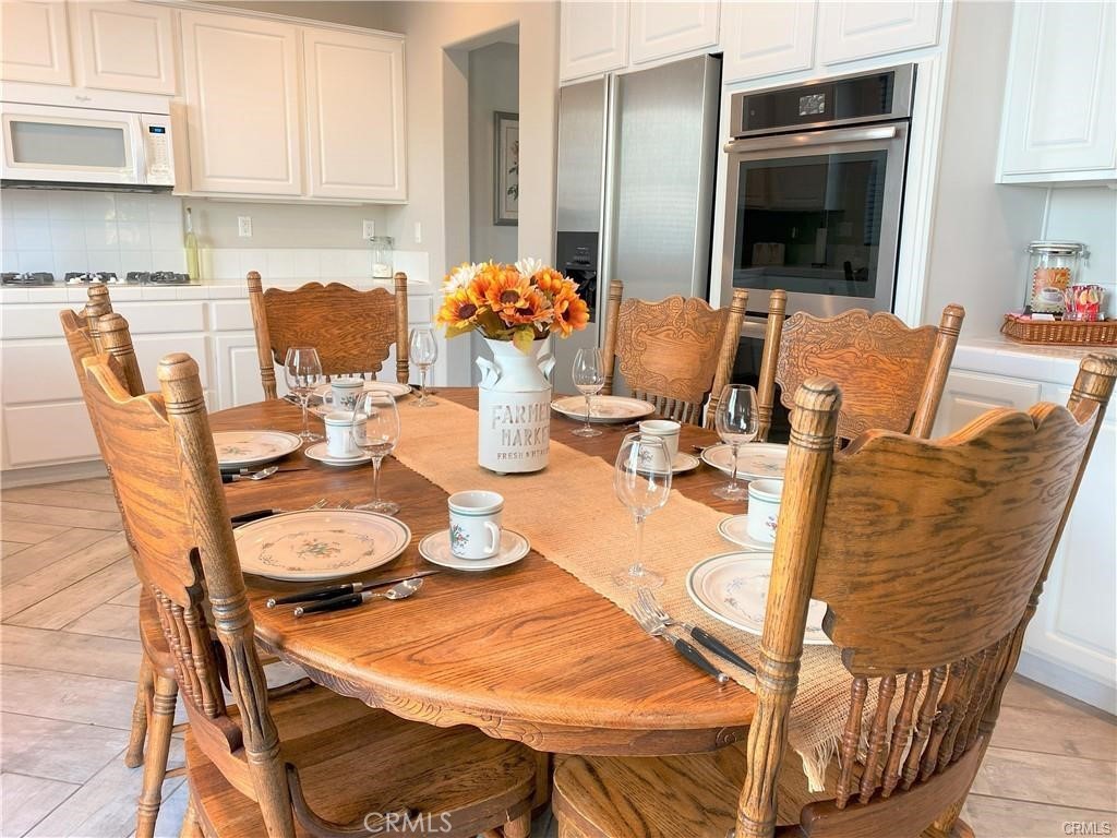 23 Bedstraw Loop Ladera Ranch, CA 92694 - Photo 6 of 37 a dining room with furniture and wooden floor