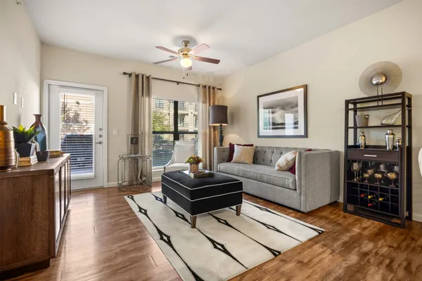 a living room with furniture a window and a chandelier