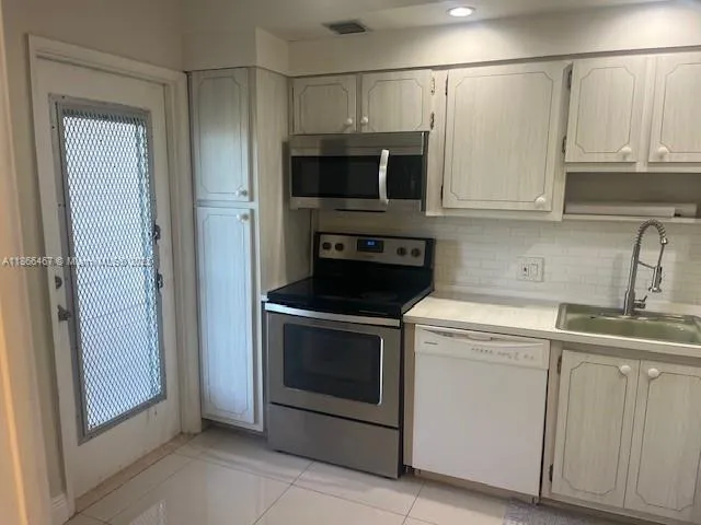 a kitchen with stainless steel appliances granite countertop a stove and a microwave