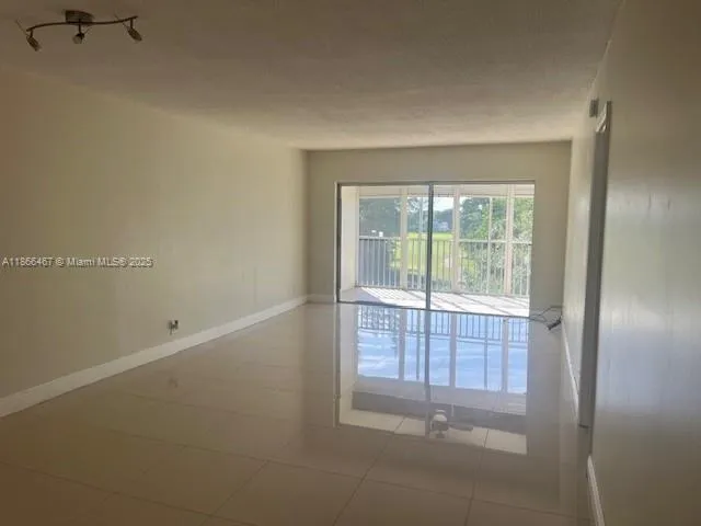 a view of empty room with floor to ceiling window
