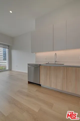 a kitchen with cabinets and a wooden floor
