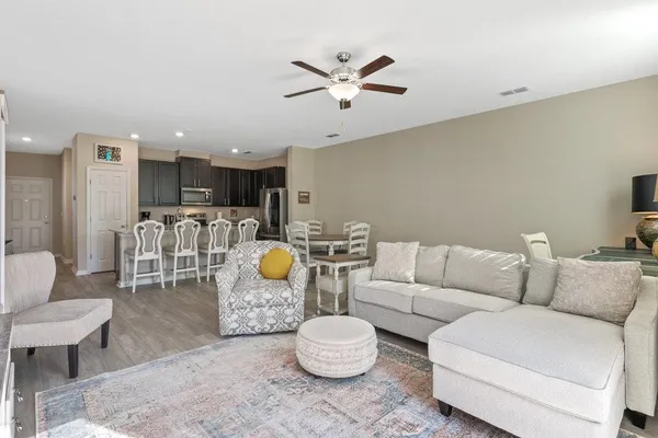 a living room with furniture and kitchen view