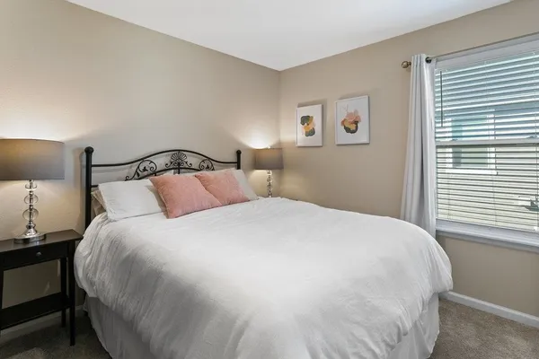 a bedroom with a bed and a night stand