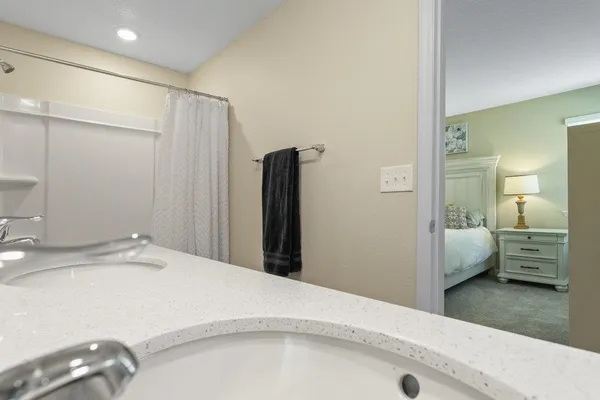 a bedroom with a bed and a large mirror