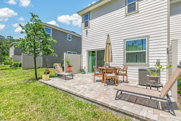 a view of a house with backyard and sitting area