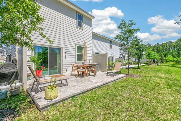 a view of a house with backyard and sitting area