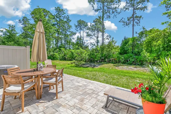 a view of a chairs and table in backyard of the house