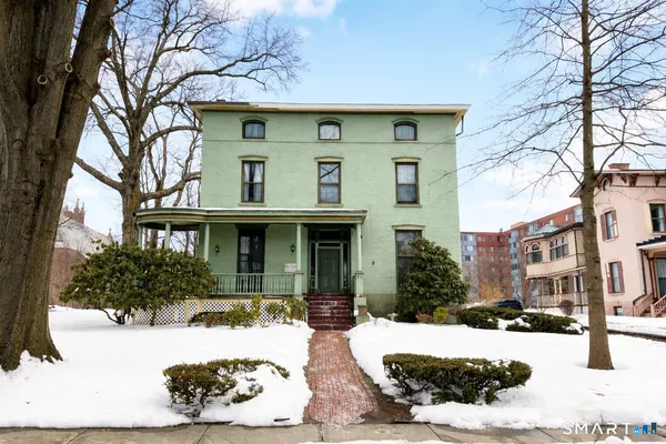 a view of a house with snow on the tree