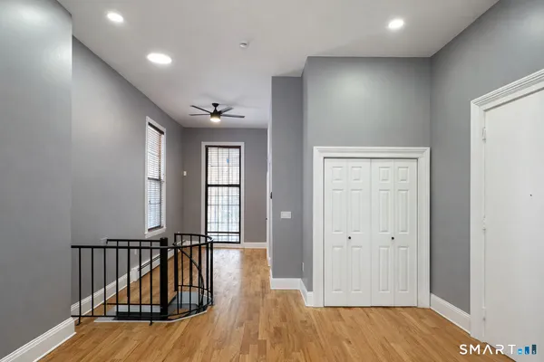 wooden floor with windows and stairs