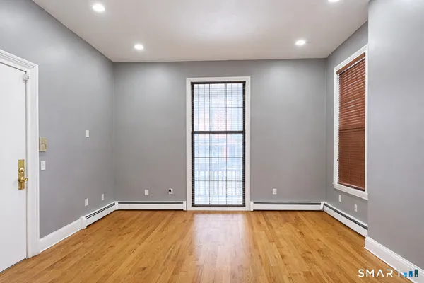 wooden floor in an empty room with a window