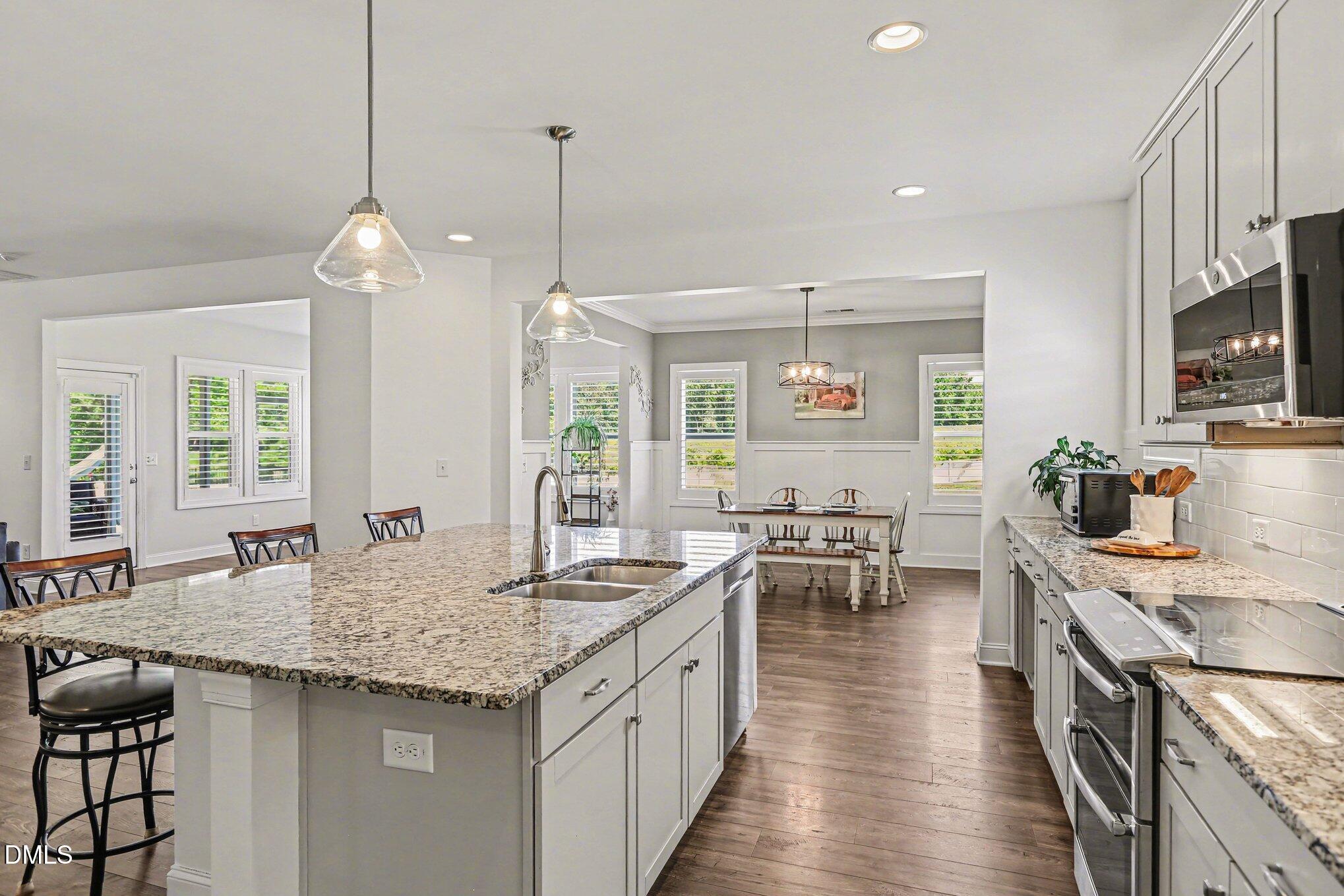 432 Seabring Lane Raleigh, NC 27603 - Photo 12 of 29 a kitchen with stainless steel appliances granite countertop a stove and a sink