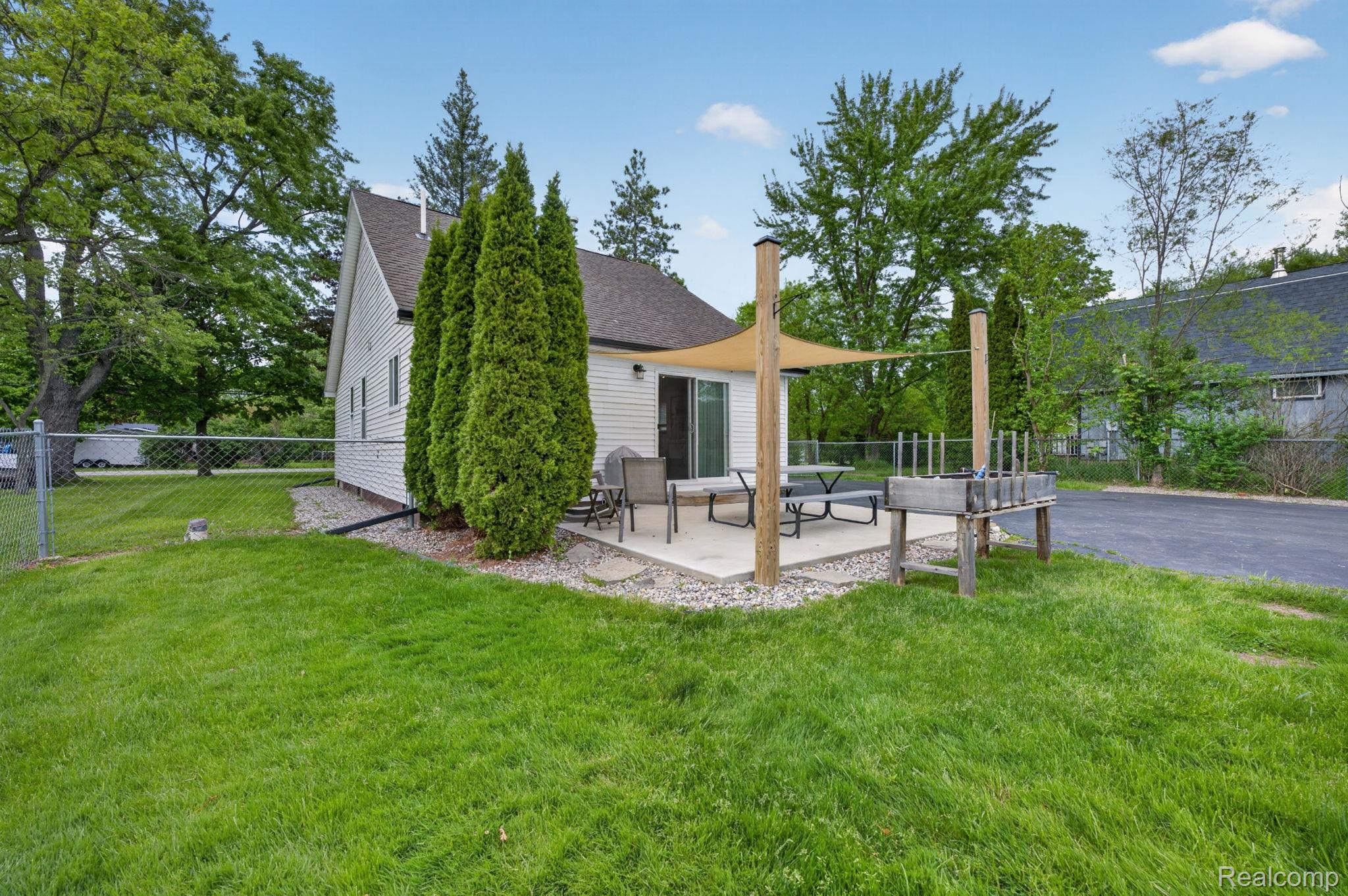 6354 Lapeer Road Burton, MI 48509 - Photo 32 of 44 Back of house featuring a patio area