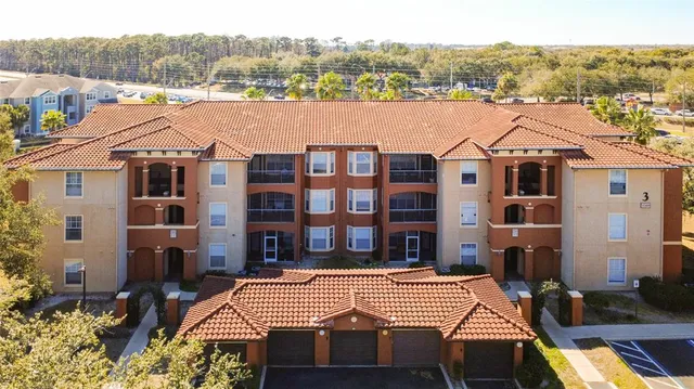 an aerial view of multiple houses with a yard