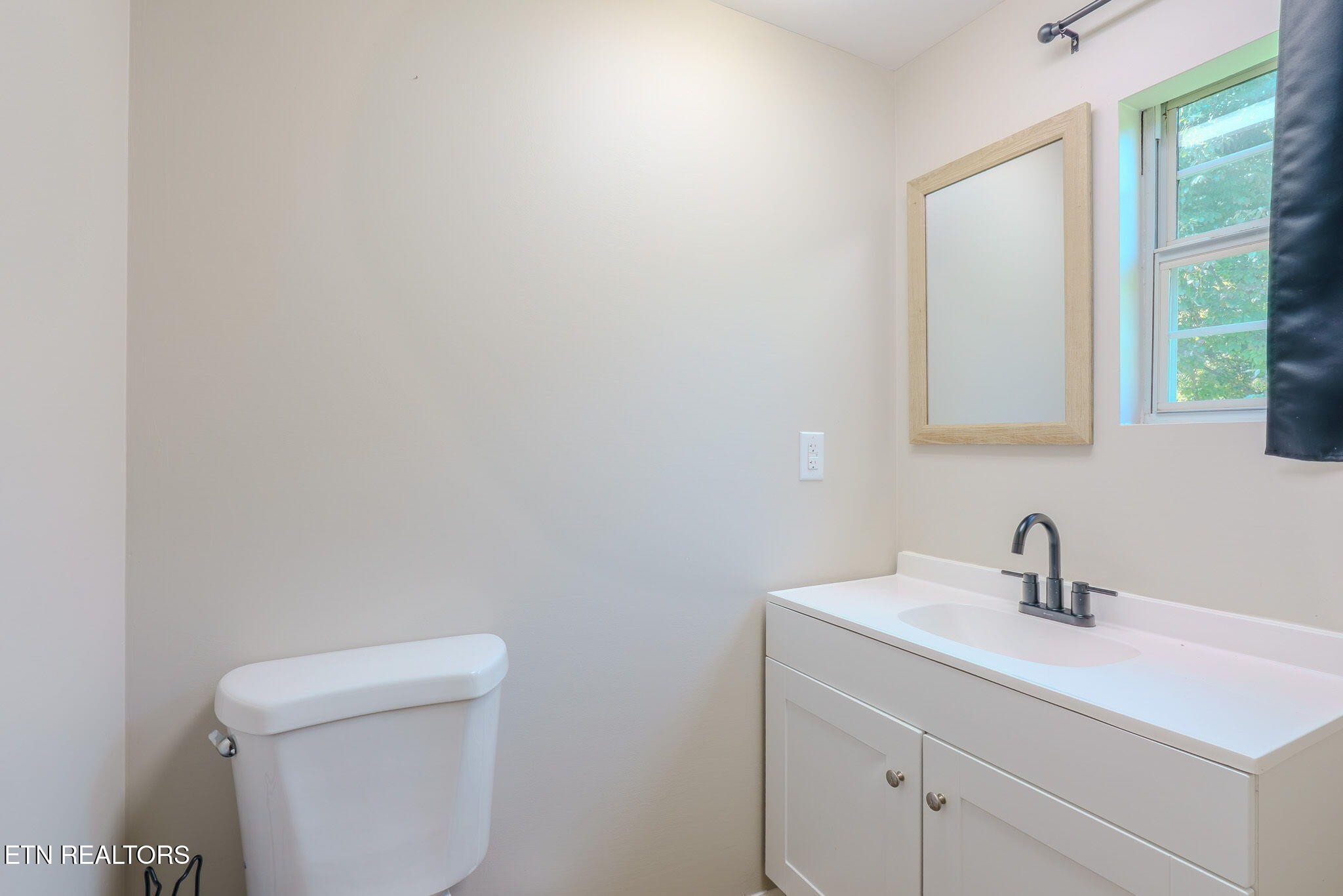 2331 Webb Road Sevierville, TN 37876 - Photo 18 of 23 a bathroom with a toilet a sink a vanity and mirror