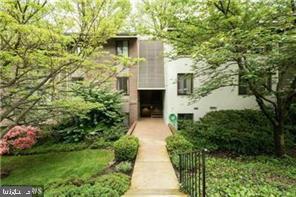 a front view of a house with plants and garden