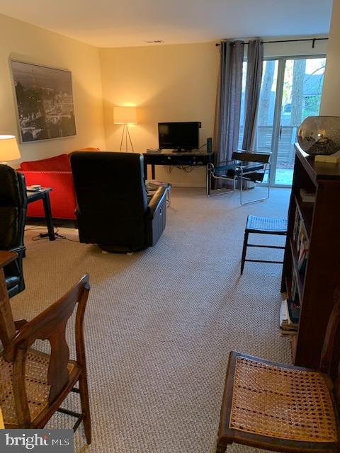 116 Cross Keys Road, Unit A A Baltimore, MD 21210 - Photo 12 of 15 a living room with furniture a flat screen tv and large windows