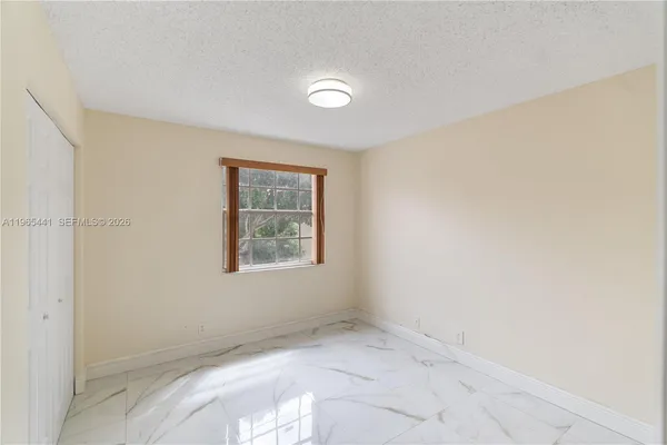 an empty room with closet area