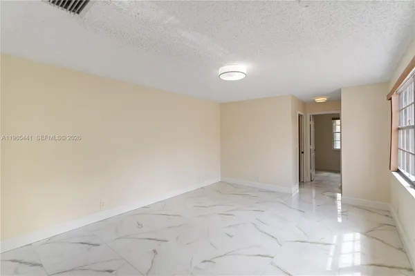 a view of an empty room with a window
