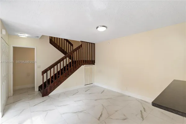 a bathroom with a granite countertop sink and washing machine